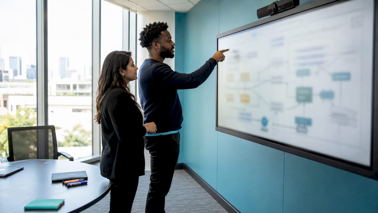 Hands pointing at a failure-mode whiteboard diagram